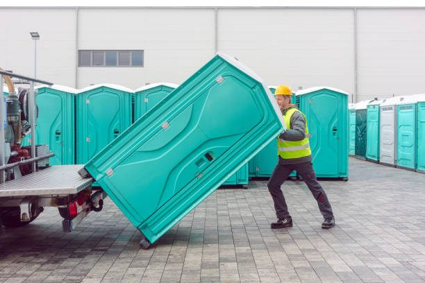 Crew delivering a portable restroom unit quickly
